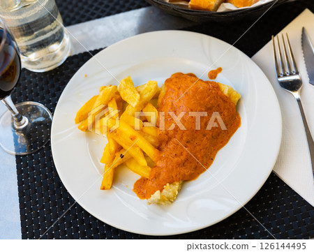 Piece of fried cod fillet covered with pureed thick escalivada sauce Piece of fried cod fillet covered with pureed thick escalivada sauce 126144495