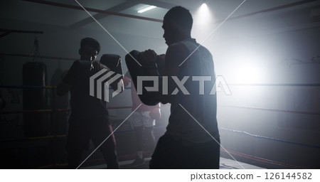 Personal trainer, sports and team with men in boxing ring for sparring practice, boxer training and fitness coaching. Mma club, wrestling and martial arts fighter with people in gym for partner 126144582