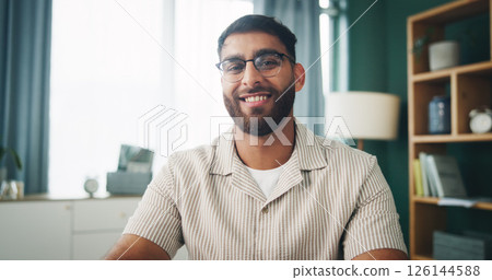 Portrait, glasses and happy man in apartment for relax, peace or calm on weekend break in home. Smile, living room and male person with spectacles for vision, resting and chill with confidence in UAE 126144588
