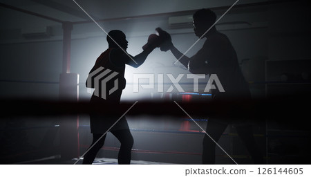 Boxing, coaching and silhouette with men in ring for sparring practice, training or fitness team. Mma club, wrestling and martial arts fighter with people in gym for personal trainer and self defense Boxing, coaching and silhouette with men in ring for sparring practice, training or fitness team. Mma club, wrestling and martial arts fighter with people in gym for personal trainer and self defense 126144605