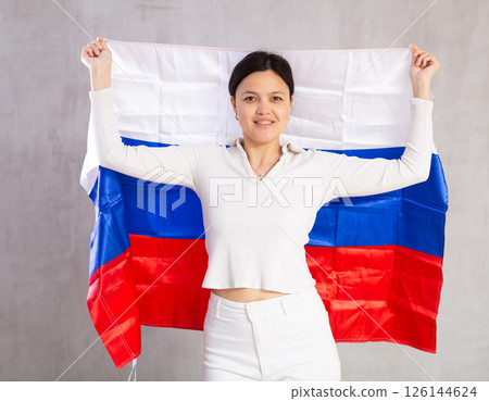 Young woman posing in studio with flag of Russia Young woman posing in studio with flag of Russia 126144624