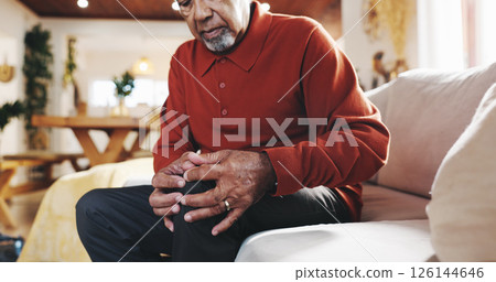 Mature man, knee pain and arthritis on couch in home, massage leg and joint problem with gout. Hands, senior person and bone inflammation with rheumatism, crisis and living room with strain injury 126144646
