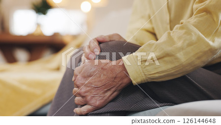 Hands, inflammation and knee pain with mature person on sofa in living room of home for arthritis. Accident, emergency or joint injury and senior in apartment with osteoarthritis or tendinitis Hands, inflammation and knee pain with mature person on sofa in living room of home for arthritis. Accident, emergency or joint injury and senior in apartment with osteoarthritis or tendinitis 126144648