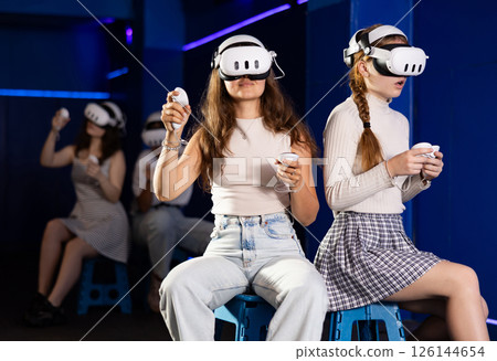 Girls wearing VR headsets and playing games. Modern bachelorette party 126144654