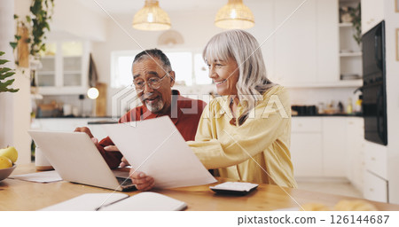 Senior couple, laptop and finance in kitchen for results, documents or smile with review for pension. Elderly people, man and woman by pc with budget, happy and profit for retirement income in home Senior couple, laptop and finance in kitchen for results, documents or smile with review for pension. Elderly people, man and woman by pc with budget, happy and profit for retirement income in home 126144687