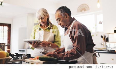 Tablet, cooking and mature couple in kitchen in home with recipe for dinner, meal or dish. Digital technology, ingredients and man with woman for preparing supper with food tutorial together in house Tablet, cooking and mature couple in kitchen in home with recipe for dinner, meal or dish. Digital technology, ingredients and man with woman for preparing supper with food tutorial together in house 126144693
