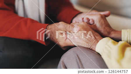 Holding hands, senior couple and comfort in home with care, love and prayer for faith in retirement. People, connection and support with bonding, trust and loyalty with relationship at apartment 126144757