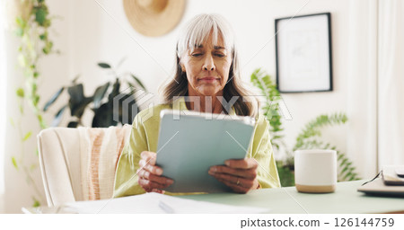 Worry, reading and tablet with old woman at home for retirement fund savings, life insurance payment and anxiety. Tax audit, bankruptcy and loan interest with senior person in apartment for debt 126144759