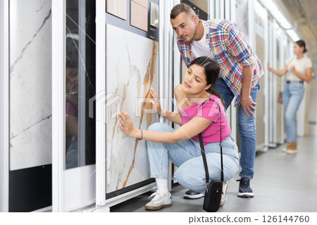 Married couple chooses floor tiles for their home together Married couple chooses floor tiles for their home together 126144760