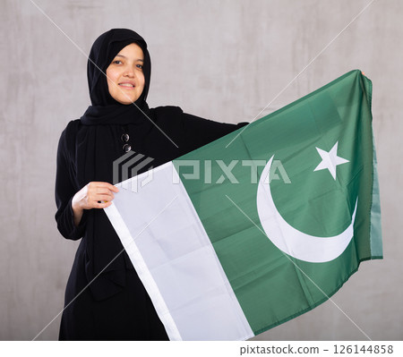 Young woman in hijab posing with Pakistan flag 126144858