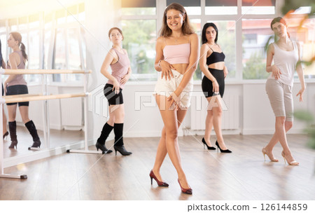 Expressive young girl partaking in group sass dance class Expressive young girl partaking in group sass dance class 126144859
