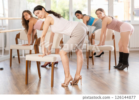 Beautiful graceful chair dance class practice at wall and window hall 126144877