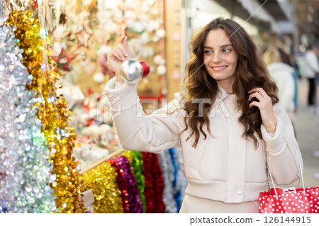 Woman choosing Christmas balls 126144915