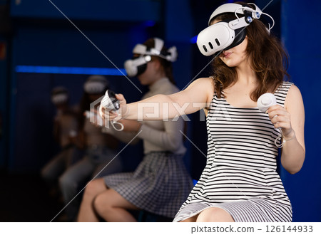 Girls using virtual reality glasses - girlfriends having fun with vr headset Girls using virtual reality glasses - girlfriends having fun with vr headset 126144933