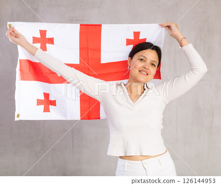 Young woman posing in studio with Georgia flag 126144953