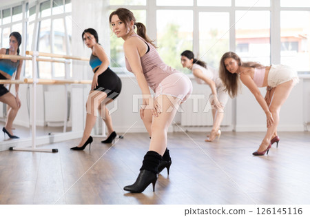 Young girl performing sass dance during group class in studio Young girl performing sass dance during group class in studio 126145116