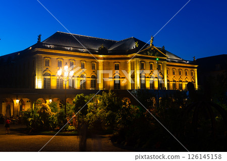 Illuminated Metz Opera surrounded by landscaped park on summer evening 126145158
