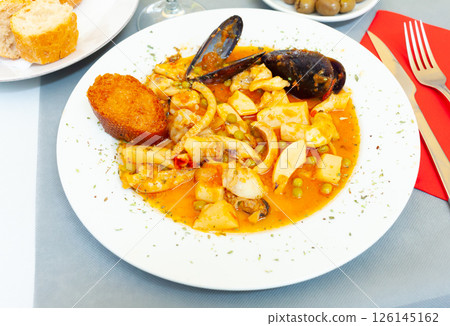 Tasty dish of spanish cuisine fried sepia with mussels in sauce Tasty dish of spanish cuisine fried sepia with mussels in sauce 126145162