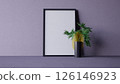 A minimalistic interior scene featuring a blank picture frame, a vibrant plant in a yellow vase, and a sleek black vase against a textured purple background. 3d rendering. 126146923