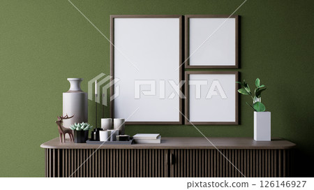 A modern interior scene featuring a green wall, decorative empty frames, a vase, candles, and small plants on a stylish wooden console table. 3d rendering. A modern interior scene featuring a green wall, decorative empty frames, a vase, candles, and small plants on a stylish wooden console table. 3d rendering. 126146927