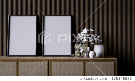 A modern interior scene featuring a wooden console with empty frames and decorative flowers against a textured wall. 126146928