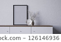 A minimalist interior scene featuring a blank frame, a decorative vase with dried flowers, and a stylish surface, 3d rendering blank frame grey wall for copy space advertising. 126146936