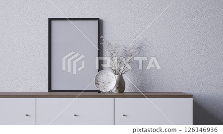 A minimalist interior scene featuring a blank frame, a decorative vase with dried flowers, and a stylish surface, 3d rendering blank frame grey wall for copy space advertising. A minimalist interior scene featuring a blank frame, a decorative vase with dried flowers, and a stylish surface, 3d rendering blank frame grey wall for copy space advertising. 126146936