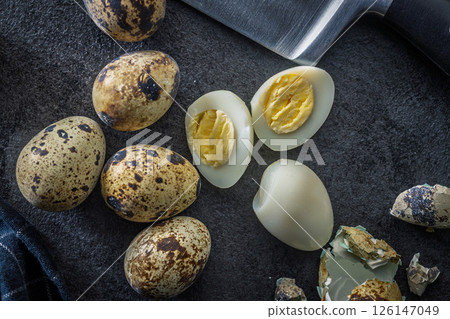 Boiled quail eggs on black table. Top view. Boiled quail eggs on black table. Top view. 126147049