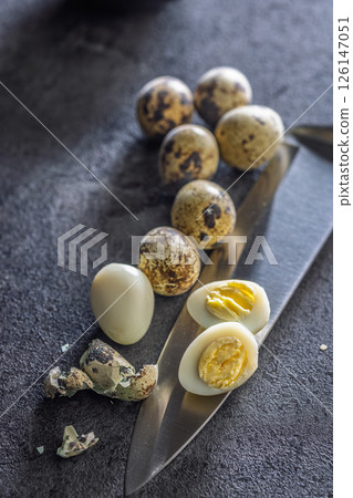 Boiled quail eggs on black table. 126147051