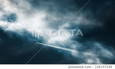 A large passenger plane flying in a beautiful sunset and a sea of clouds 126147286