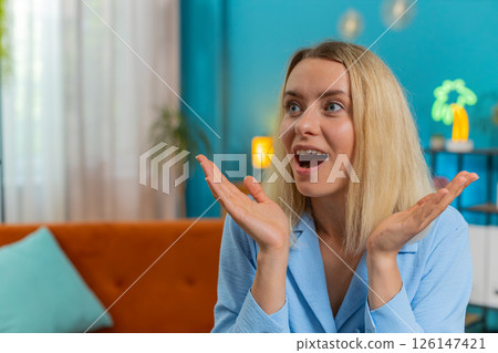 Woman surprised looking at side with big eyes, shocked by sudden victory good win news celebrating 126147421