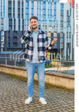 Mature Caucasian man having conversation communicate speaking by smartphone in downtown city street 126147499