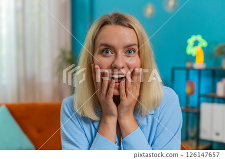 Woman surprised looking at camera with big eyes, shocked by sudden victory good win news celebrating Woman surprised looking at camera with big eyes, shocked by sudden victory good win news celebrating 126147657