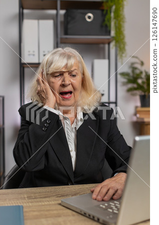 Elderly employer freelancer using laptop working at home office having nervous breakdown at work Elderly employer freelancer using laptop working at home office having nervous breakdown at work 126147690