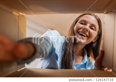 Happy Caucasian woman girl shopper unpacking cardboard box delivery parcel online shopping purchase Happy Caucasian woman girl shopper unpacking cardboard box delivery parcel online shopping purchase 126147719