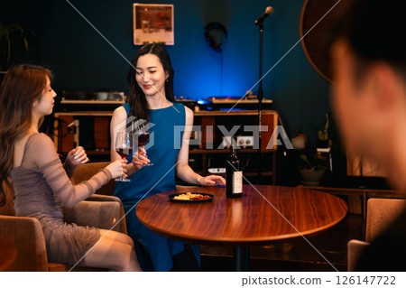 Group of women drinking at a bar Group of women drinking at a bar 126147722