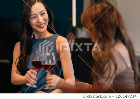 Group of women drinking at a bar 126147734