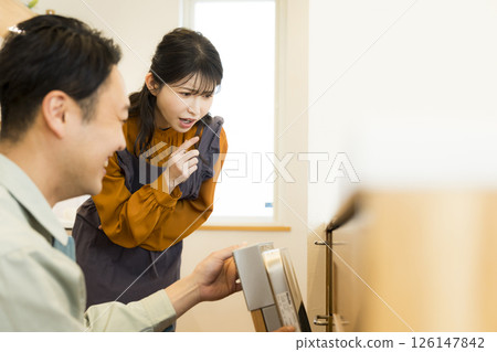 Male worker repairing a dishwasher Male worker repairing a dishwasher 126147842