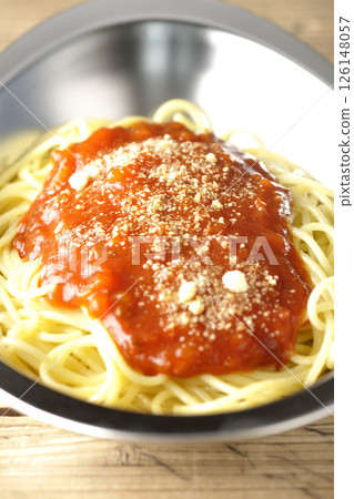 Meat sauce pasta topped with grated cheese 126148057