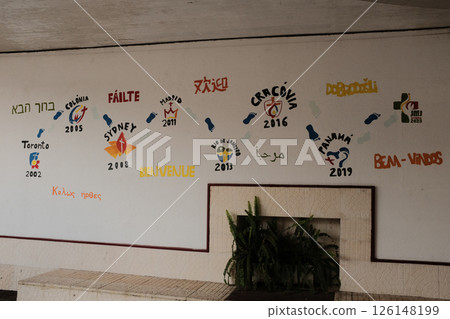 Vibrant multilingual welcome wall mural with international greetings and travel icons at Lisbon train station interior colorful artistic decoration for cultural diversity. High quality photo Vibrant multilingual welcome wall mural with international greetings and travel icons at Lisbon train station interior colorful artistic decoration for cultural diversity. High quality photo 126148199