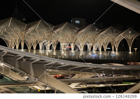 Modern illuminated architecture of Oriente Station at night in Lisbon Portugal featuring geometric roof design arches and empty railway tracks in futuristic urban environment. High quality photo Modern illuminated architecture of Oriente Station at night in Lisbon Portugal featuring geometric roof design arches and empty railway tracks in futuristic urban environment. High quality photo 126148209