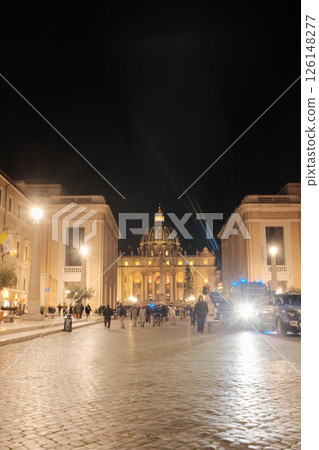 Night view of Saint Peters Basilica from Via della Conciliazione Rome with people walking illuminated streetlights and symmetrical architecture. High quality photo Night view of Saint Peters Basilica from Via della Conciliazione Rome with people walking illuminated streetlights and symmetrical architecture. High quality photo 126148277