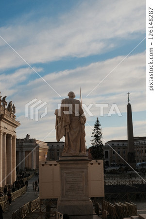 Saint Peters Basilica with red banners statues and crowd of visitors in Vatican City under sunny blue sky during special event or Papal address. High quality photo Saint Peters Basilica with red banners statues and crowd of visitors in Vatican City under sunny blue sky during special event or Papal address. High quality photo 126148287