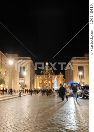 Night view of Saint Peters Basilica from Via della Conciliazione Rome with people walking illuminated streetlights and symmetrical architecture. High quality photo Night view of Saint Peters Basilica from Via della Conciliazione Rome with people walking illuminated streetlights and symmetrical architecture. High quality photo 126148419