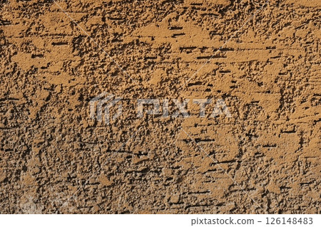 Weathered old textured brown wall surface close up with rough dark peeling stucco paint and aged damaged concrete grunge detail background for construction and architectural use. High quality photo Weathered old textured brown wall surface close up with rough dark peeling stucco paint and aged damaged concrete grunge detail background for construction and architectural use. High quality photo 126148483