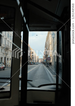 Interior of Roman church with ornate altar and exterior souvenir kiosk shop on traditional street capturing daily life and religion in Rome Italy. High quality photo 126148568