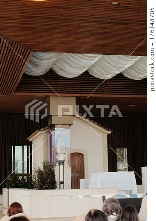 Chapel of the Apparitions at Sanctuary of Fatima Portugal showing simple modern altar under wooden canopy sacred Catholic pilgrimage site marking location of Virgin Mary 1917 apparitions. High quality Chapel of the Apparitions at Sanctuary of Fatima Portugal showing simple modern altar under wooden canopy sacred Catholic pilgrimage site marking location of Virgin Mary 1917 apparitions. High quality 126148705