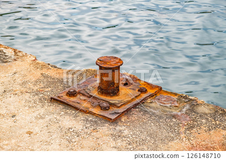 rusty old bollard on concrete pier, close-up 126148710