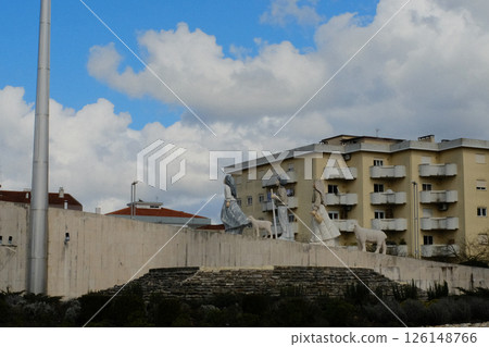 Tall modern monument with vertical white pillar in residential neighborhood of Fatima Portugal with surrounding buildings under blue sky and clouds. High quality photo Tall modern monument with vertical white pillar in residential neighborhood of Fatima Portugal with surrounding buildings under blue sky and clouds. High quality photo 126148766