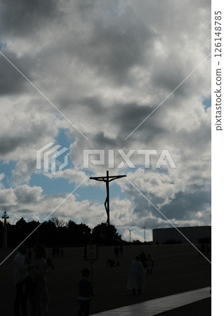High Cross monument at Sanctuary of Fatima Portugal silhouetted against cloudy sky symbol of Christian faith at iconic Catholic pilgrimage site. High quality photo High Cross monument at Sanctuary of Fatima Portugal silhouetted against cloudy sky symbol of Christian faith at iconic Catholic pilgrimage site. High quality photo 126148785